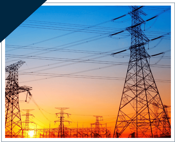 A picture of power lines and towers at sunset.