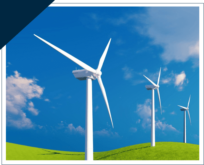 A group of wind turbines on top of green grass.