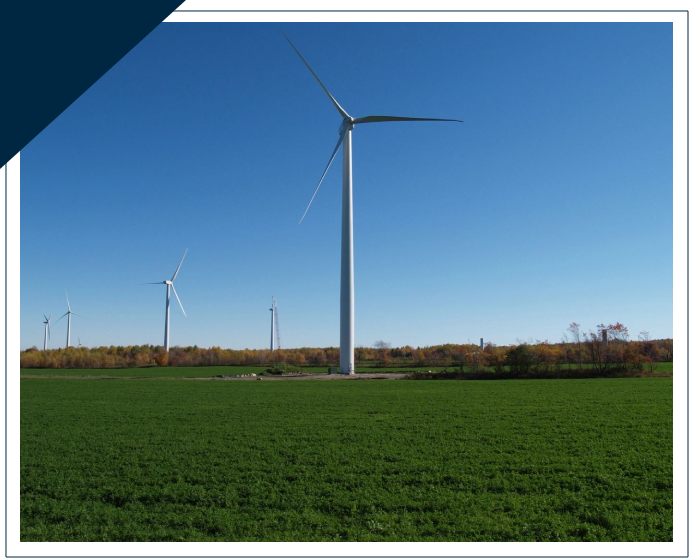 A wind turbine in the middle of a field.